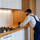 Kitchen installer finalizing cabinet installation