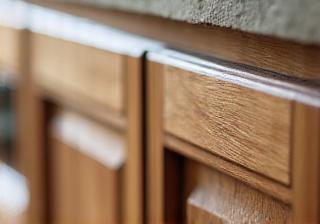 Close-up of custom kitchen cabinetry with artisan woodworking details